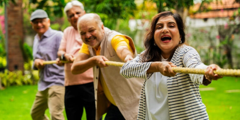 Group of Elderly Adults Enjoying Tug-of-War in Memory Care