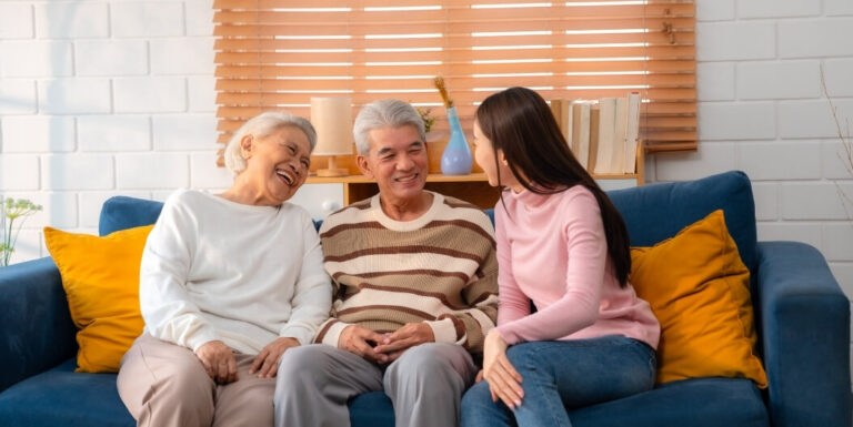 Elderly Couple Chatting with Family Member at Assisted Living Facility