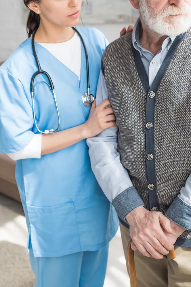 Nurse Comforting Elderly Woman at Nursing Home Oxford